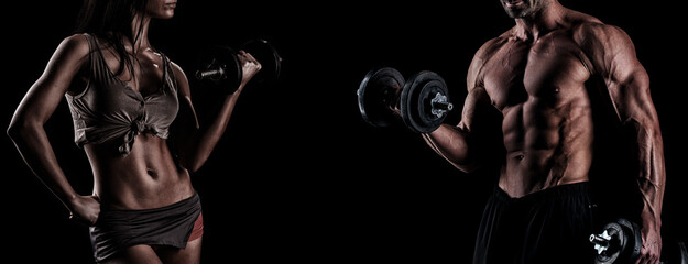 strong young couple working out with dumbbells. Shot in studio on a dark background.