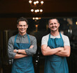 © Hira/peopleimages.com - Team, restaurant and portrait of man with confidence, professional and people for small business startup. Happy, owner and pride for success in career in hospitality service, growth and together.
