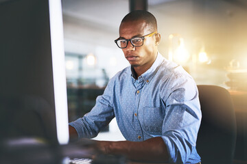 Leinwandbilder - Office, computer and business black man at night for website, research and programming at desk. Startup, developer and worker online for software update, networking and working on web design