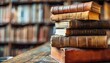 © RESTY - literature reading concept banner or header image with stack of antique leather bound books against a dark background
