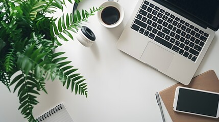 Wall Mural - Modern white office desk table with laptop computer, notepad, plant, headphones and cup of coffee. Flat lay, top view, copy space