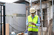 © Art_Photo - Professional of team architect industrial engineer in helmet working new construction project architectural plan with blueprint and construction tool on table at the building construction site