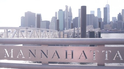 Wall Mural - New York City Manhattan downtown skyline, financial district waterfront cityscape. Pier in Dumbo near Brooklyn Bridge, East river. World Trade Center skyscraper. Iconic riverfront view, railing sign.