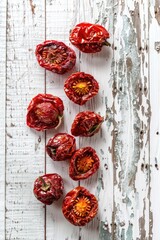 A group of red peppers sitting on top of a wooden table