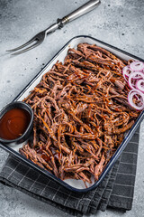 Sticker - Pulled beef meat with hot chili sauce in baking dish. Gray background. Top view