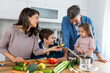© Graphicroyalty - Overjoyed young family with son and daughter have fun cooking diner or lunch at home together, happy smiling parents enjoy weekend play with small children doing cooking in kitchen