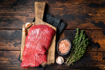 Wall Mural - Alternative flank beef steak, raw meat. Wooden background. Top view