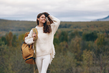 Poster - Mountain Adventure: Smiling Woman on Cliff, Embracing Nature's Freedom