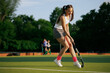 © st.kolesnikov - girl hockey player plays field hockey on a sunny day, the hockey player hits the ball with a stick