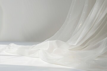 Wall Mural - a soft, white sheer fabric with subtle sparkles flows gently on a plain white background. the light 