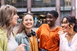 © Westend61 - Cheerful female friends talking in city