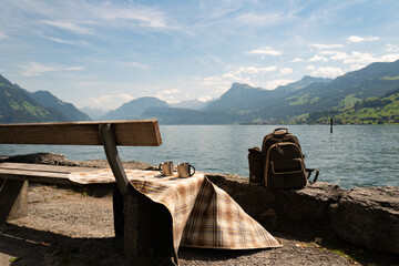 Wall Mural - Travel in the mountains. Tourism in Alps lake and mountains. Tourism concept. Hiking backpack near nature of Switzerland. Switzerland landscape. Camping and trekking equipment.