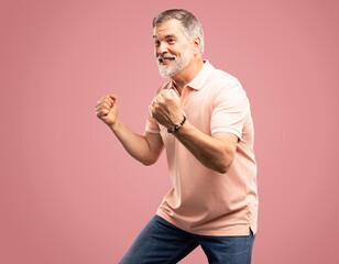 Sticker - Portrait of a satisfied mature man celebrating success isolated over pink background.