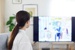 © west_photo - リビングにてテレビを見る日本人の女性の後ろ姿