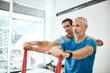 © StarDweller/peopleimages.com - Fitness, physiotherapist and mature man with resistance band in clinic for physical therapy, support or mobility exercise. Health, male doctor and patient for help, stretching arms or rehabilitation