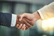 © AK Coop/peopleimages.com - Business, office and people with handshake for agreement or deal and partnership for opportunity. Corporate, welcome and greeting or well done with support in meeting for teamwork and collaboration