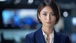 © decorator - Japanese female news anchor reporting in studio with serious expression on news program, front view