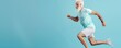 © Dalibor - Senior man jumping in a gym with a blue background. Free copy space for banner.