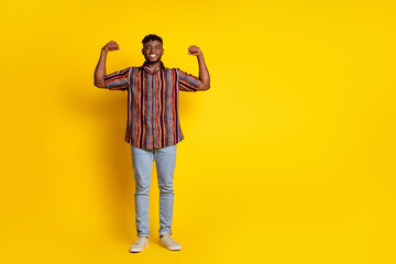 Full body portrait of nice young man flex biceps empty space wear shirt isolated on yellow color background