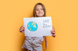 © ADDICTIVE STOCK - Young girl holding a Save the Planet sign