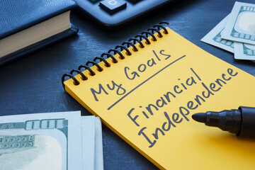 notebook with handwritten inscription my goals financial independence.