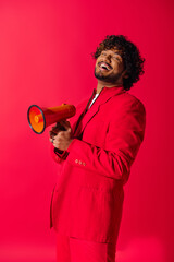 Wall Mural - Handsome Indian man in red suit with red and yellow megaphone.