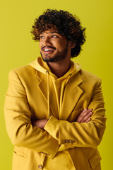 Wall Mural - Handsome young man in yellow suit with arms crossed.