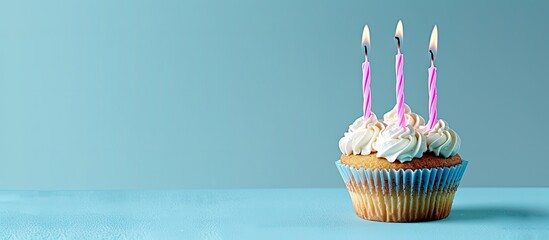 Aufkleber - A birthday cupcake with pink candles against a blue backdrop, ideal for adding text or graphics with copy space image.