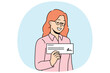 © Dzianis Vasilyeu - Woman with paycheck in hand smiles demonstrating financial document confirming receipt of salary or bonus. Signed paycheck in hands of businesswoman who closed deal and received payment from buyer