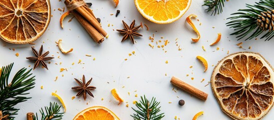 Poster - A Christmas-themed frame consisting of dried oranges, spices, cinnamon sticks, and coniferous branches on a white surface with ample copy space for text or images.