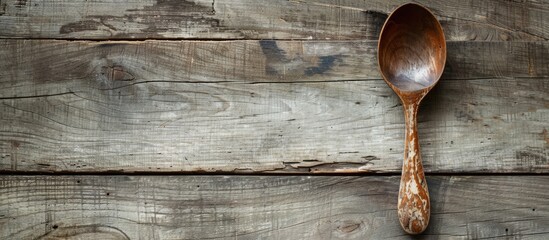 Wall Mural - Rustic spoon in a creative design concept with copy space image for food ideas.