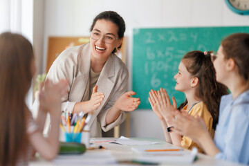 Wall Mural - Happy kids and teacher at school