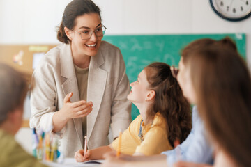 Wall Mural - Happy kids and teacher at school