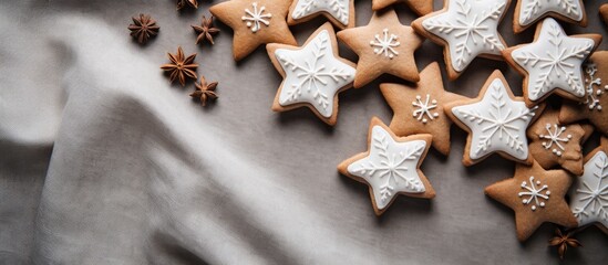 Canvas Print - Star-shaped gingerbread cookies with royal icing decoration on a linen backdrop, ideal for the holiday season with a suitable copy space image.