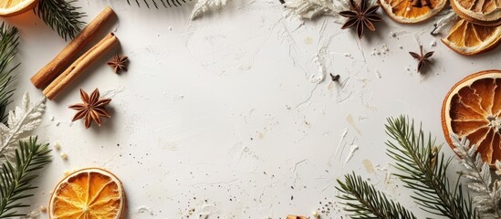Poster - A Christmas-themed frame consisting of dried oranges, spices, cinnamon sticks, and coniferous branches on a white surface with ample copy space for text or images.