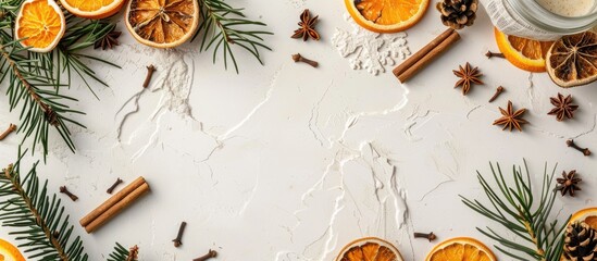 Poster - A Christmas-themed frame consisting of dried oranges, spices, cinnamon sticks, and coniferous branches on a white surface with ample copy space for text or images.