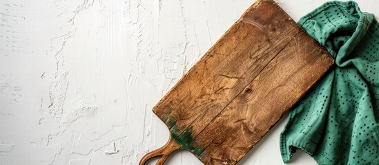 Aufkleber - A vintage rectangular cutting board with a handle is placed on a white table beside a green towel, accompanied by a blank area on the left for text or design in a copy space image.