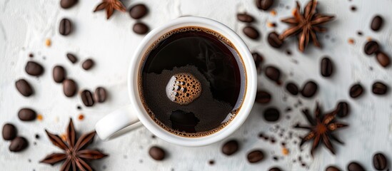 Aufkleber - A white cup filled with black aromatic coffee rests on a light table surrounded by roasted beans and an anise star, providing copy space in the image.