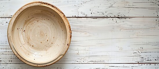Aufkleber - Top-down view of an empty ceramic bowl on a white wooden table, with room for adding text or a copy space image included.