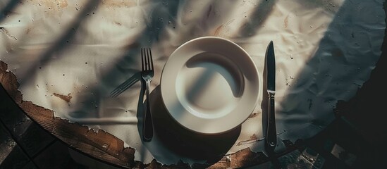 Aufkleber - Top-down view of a table setting featuring white plates, a fork, and a knife, ideal for a 'copy space image.'
