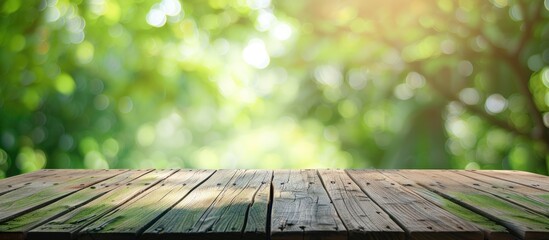 Poster - Wooden deck table with a blurred green background, ideal for showcasing products in a copy space image.