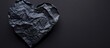 © HN Works - Crumpled paper heart on a black background provides a stylish copy space image.