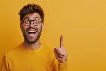 Portrait of happy man with open mouth smiling and gesturing up with index finger