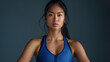 © Uwe - a asia woman with abdominal muscles on plain studio background, arms at side, wearing blue Sport clothes