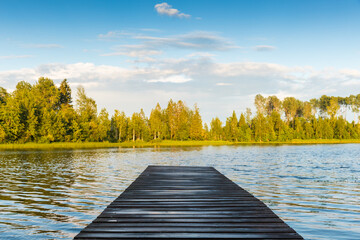 Wall Mural - An empty wet wooden swimming pier perspective view