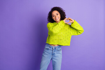 Wall Mural - Portrait photo of wavy haired student girl in green trendy sweater showing love symbol valentine day isolated on violet color background