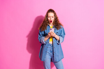 Sticker - Photo of shiny shocked lady dressed denim jacket communicating modern gadget empty space isolated pink color background