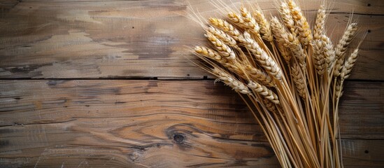 Fototapete - Wheat bouquet displayed on a wooden table creating a rustic harvest themed copy space image
