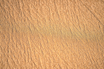 Beach sand background. Top view of a beach sand background with natural wave pattern