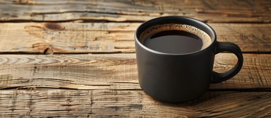 Fototapete - A black coffee cup displayed on a wooden surface with copy space image available